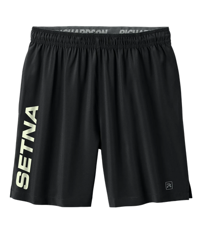 Black athletic shorts with a wide elastic waistband, featuring 'SETNA' printed vertically in light beige on the left leg and a small logo on the lower right hem, shown against a plain white background.