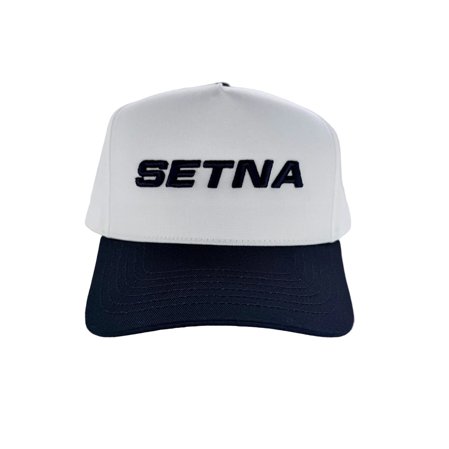 White and navy cap with 'SETNA' branding on a white background
